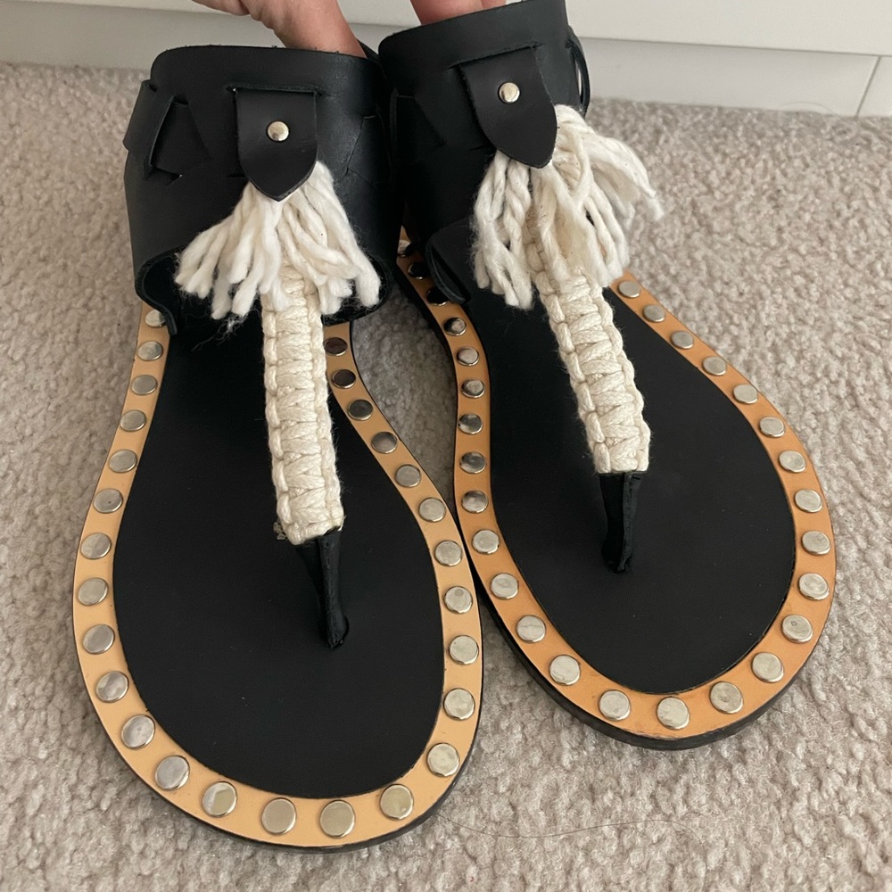 Stylish Black Flat Sandals with Natural Macramé Detail and Silver Studs.